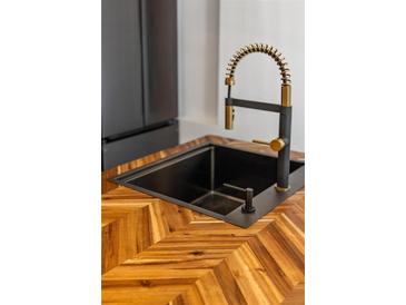Modern kitchen sink with gold faucet and herringbone wood countertop at 404 Granville Ct, Atlanta, GA 30328