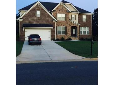 Two-story brick home with attached garage and manicured lawn at 4110 Tobiano Trl, Cumming, GA 30040