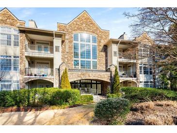 Stone building exterior with balconies and lush landscaping at 3047 Lenox Ne Rd # 1108, Atlanta, GA 30324