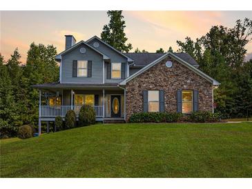 Two-story house with stone accents and a large yard at 900 Cass Pine Log Rd, Rydal, GA 30171