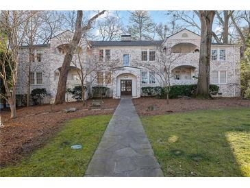 Charming brick building with stone pathway, landscaping, and ample outdoor space at 51 Peachtree Memorial Nw Dr # 4, Atlanta, GA 30309