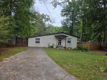 Charming single-story home featuring a well-maintained lawn and a cozy, welcoming entrance at 883 Verona Dr, Clarkston, GA 30021