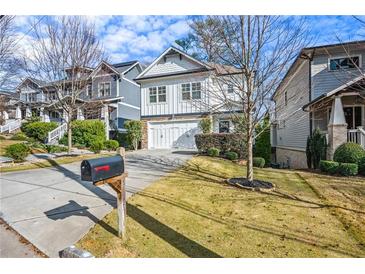 Two-story house with white siding, stone accents, and a two-car garage at 2603 Apple Valley Ne Rd, Brookhaven, GA 30319