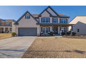 Two-story brick home with gray accents and a landscaped lawn at 5330 Austrian Pine Ct, Cumming, GA 30040