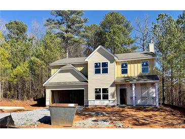 Two-story home with an attached garage is currently under construction on a sunny day at 16 Deer Place, Villa Rica, GA 30180