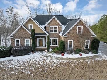 Brick home with snow covered lawn at 7801 Windswept Way, Douglasville, GA 30135