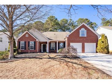 Brick home with 2-car garage and landscaped yard at 928 Buckhorn Bnd, Locust Grove, GA 30248