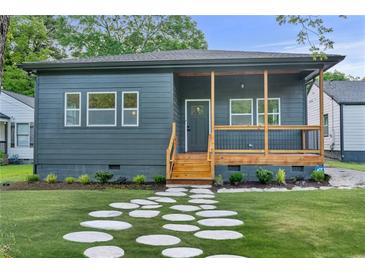 Charming single-story home featuring a welcoming front porch, stone walkway, and beautifully landscaped front yard at 639 Ozburn, Atlanta, GA 30318