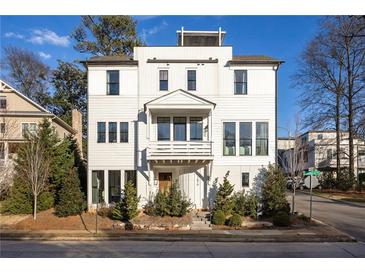 White two-story home with a front balcony and landscaping at 1870 Vigo Ne St, Atlanta, GA 30307