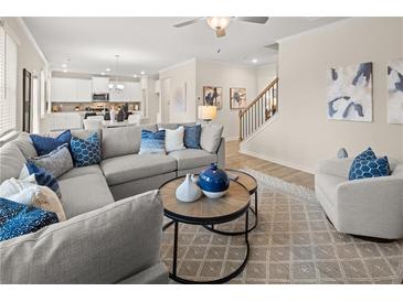 Spacious living room with large sectional sofa and stunning hardwood floors at 2210 Cormac St, East Point, GA 30344