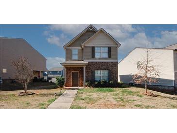 Two-story house with brick and siding, landscaping, and walkway at 208 Magnaview Dr, Mcdonough, GA 30253