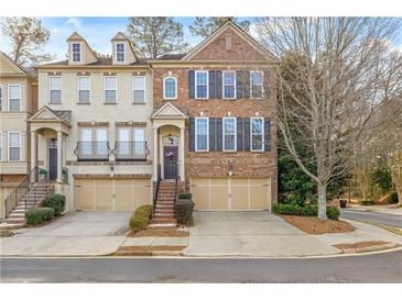 Brick front townhouse with 2-car garage, steps, and landscaping at 2827 Overlook Ne Trce, Atlanta, GA 30324