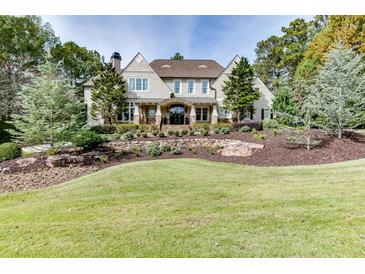 Two-story house with stone accents and landscaping at 923 Little Darby Ln, Suwanee, GA 30024