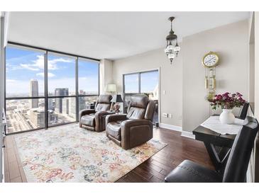 Relaxing living room with city views and comfortable recliners at 1280 W Peachtree Nw St # 3902, Atlanta, GA 30309