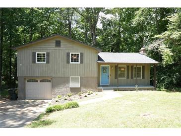 Ranch home with attached garage, blue door, and landscaped yard at 34 Timber Chase Dr, Dallas, GA 30157