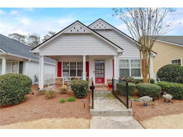 Charming one-story home with a welcoming front porch and manicured landscaping at 3529 Flowering Spgs, Powder Springs, GA 30127