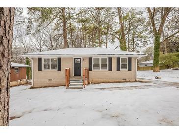 Ranch style home with snow covered yard at 29 Oak Sw Dr, Atlanta, GA 30354