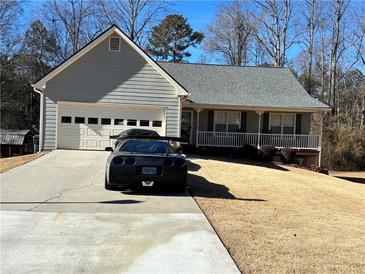 Ranch style home with attached garage and porch at 399 Towler Dr, Loganville, GA 30052