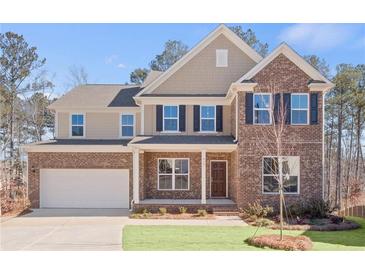 Brick two-story house with a white garage door and landscaped lawn at 6075 Marigold Way, Atlanta, GA 30349