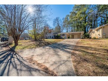 Ranch home with a long driveway and mature trees at 2725 Rainbow Forest Dr, Decatur, GA 30034