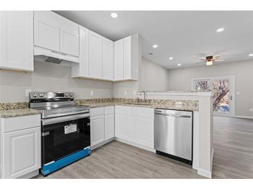 Modern kitchen with stainless steel appliances and granite countertops at 6093 Camden Forrest Ct, Riverdale, GA 30296