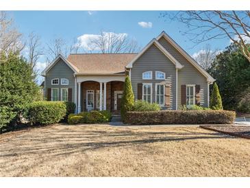 Gray siding, brown shutters, and a welcoming front porch characterize this charming house at 4280 Talaton Ct, Cumming, GA 30028