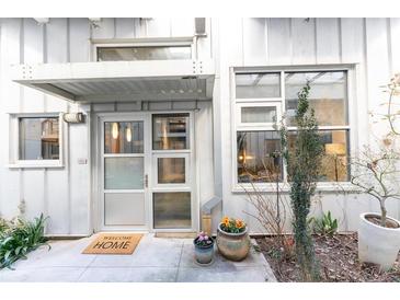 Contemporary home's entrance boasts a covered front door, complemented by potted plants and a clear view inside at 1661 La France St # 102, Atlanta, GA 30307