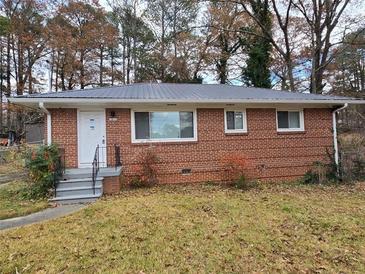 Brick ranch home with a metal roof, steps, and a yard at 2842 Delowe Dr, Atlanta, GA 30344