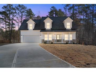 Two-story farmhouse with a white exterior, gray roof, and a large front porch at 56 Veranda Walk, Dallas, GA 30157