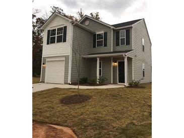 Two-story house featuring a gray exterior, white accents, and a two-car garage at 1188 To Lani Path, Stone Mountain, GA 30083