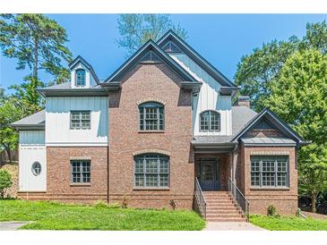 Brick and white two-story house with gray accents and landscaping at 630 Darlington Commons Ne Ct, Atlanta, GA 30305