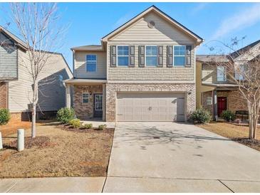 Two-story house with brick and siding exterior, two-car garage, and landscaping at 757 Galveston Way, Mcdonough, GA 30253