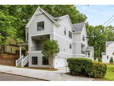 Two-story craftsman style home with gray siding, white trim, and a detached two-car garage at 628 Robinson Se Ave # B, Atlanta, GA 30312
