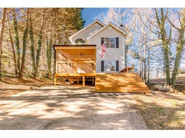 Two-story house with a large deck and screened porch at 2605 Poplar Ln, Cumming, GA 30041