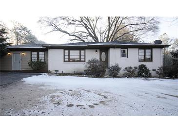 Ranch style home with snow covered front yard at 2982 Cruse Rd, Lawrenceville, GA 30044