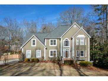 Two-story house with gray siding, dark roof, and landscaping at 103 Ashwood N Ct, Stockbridge, GA 30281