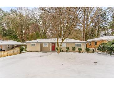 Ranch style home with red front door, snow covered yard at 2792 Plantation Dr, Atlanta, GA 30344