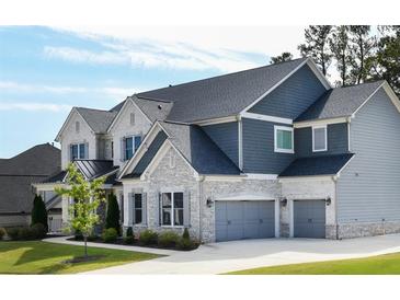 Two-story home with gray siding, stone accents, and a three-car garage at 768 Marlay Ln, Powder Springs, GA 30127