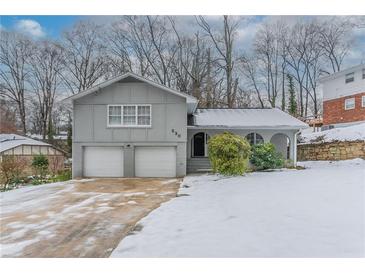 Gray house with a two-car garage and snowy front yard at 530 Balfour Dr, Decatur, GA 30032