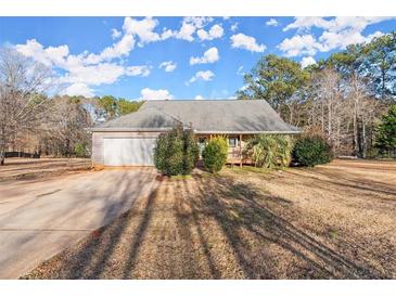 Ranch home with attached garage and large yard at 1489 New Hope Rd, Locust Grove, GA 30248
