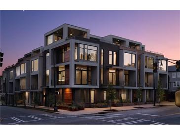Contemporary townhome building with modern design, large windows, and private balconies at dusk at 105 Georgia Se Ave # 5, Atlanta, GA 30312