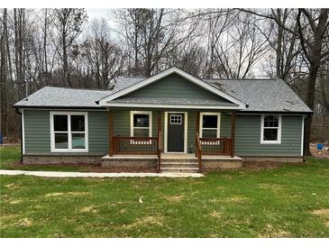 Newly constructed home with gray siding, front porch, and landscaped lawn at 10033 Florence Cir, Villa Rica, GA 30180