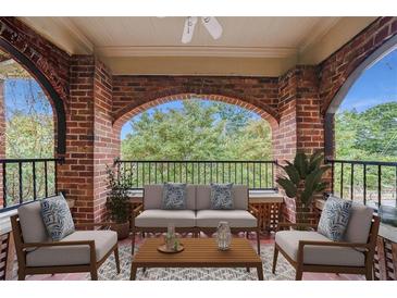 Charming patio featuring a seating area with an exterior view framed by brick columns and archways at 795 Ponce De Leon Ne Pl # C3, Atlanta, GA 30306