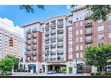 Elegant condominium building featuring brick facade, multiple balconies, and street-level retail at 2277 Peachtree Ne Rd # 405, Atlanta, GA 30309
