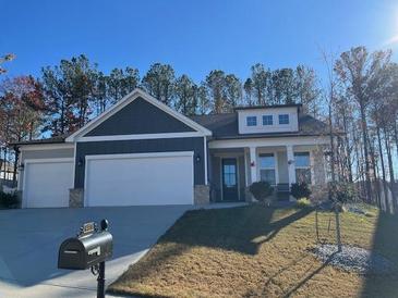 Two-story home with three-car garage and landscaped yard at 481 Riverwood Pass, Dallas, GA 30157