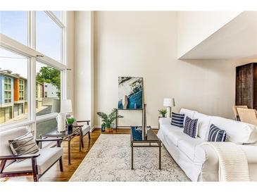 Bright living room with hardwood floors, large windows, and comfortable seating at 1390 Stirling Nw Cir, Atlanta, GA 30318