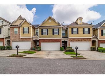 Charming townhomes with a mix of brick and siding exteriors and attached one-car garages at 53 Providence Oak Ct, Lawrenceville, GA 30046