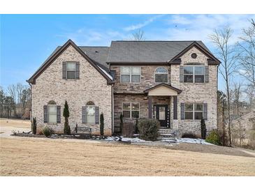 Two-story brick home with a welcoming front porch and landscaped lawn at 105 Couch Ct, Fayetteville, GA 30214