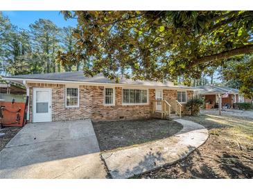 Brick ranch house with a large yard and mature trees at 1189 Rock Cut Rd, Forest Park, GA 30297