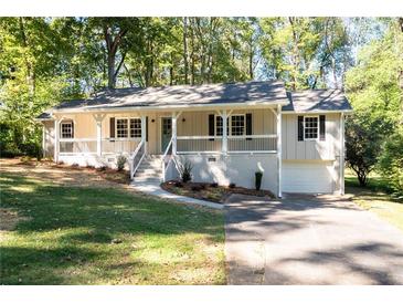 Charming ranch-style home features a welcoming front porch and a well-maintained front yard with mature trees at 2690 Old Hickory Nw Dr, Marietta, GA 30064